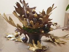 autumn centerpiece with golden leaves and acorns